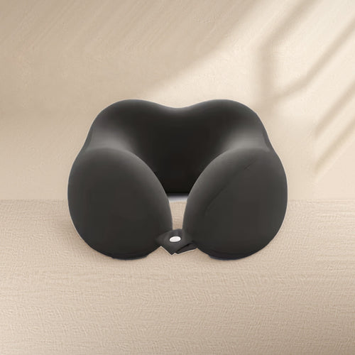 Black U-shaped memory foam travel neck pillow by Waypoint on a linen table