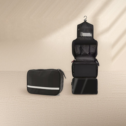 Black hanging toiletry bag by Waypoint, shown closed and opened out with its pockets empty